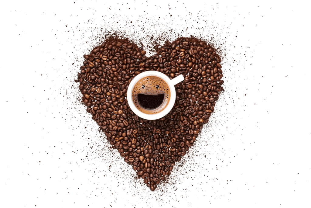 Coffee grounds arranged in a heart around an espresso cup